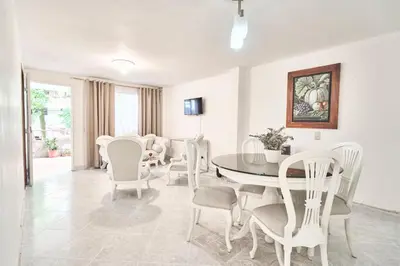 a dining room with a table and chairs at Casa grande cerca al Poblado in Medellín