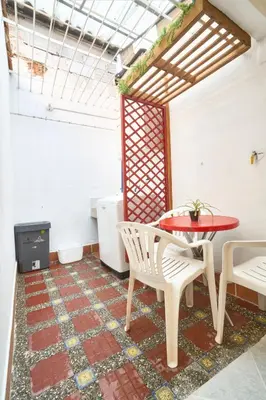 a room with a table and chairs and a tv at Casa grande cerca al Poblado in Medellín