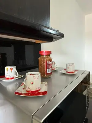 a counter with two cups and a jar of jam at APARTAMENTO EN LAURELES, Ambiente familiar in Medellín