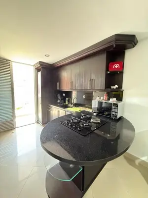 a kitchen with a black counter top in a room at APARTAMENTO EN LAURELES, Ambiente familiar in Medellín