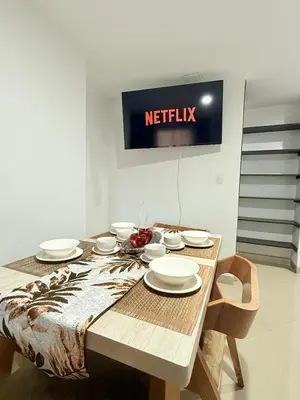 a table with plates and bowls on top of it at APARTAMENTO EN LAURELES, Ambiente familiar in Medellín