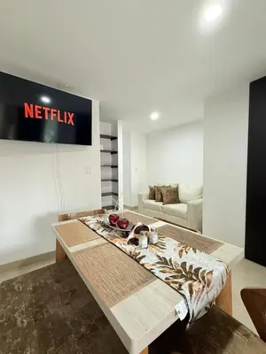 a living room with a netflix sign on the wall at APARTAMENTO EN LAURELES, Ambiente familiar in Medellín