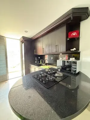 a kitchen with a black counter top with a stove at APARTAMENTO EN LAURELES, Ambiente familiar in Medellín