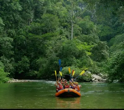 a group of people in a raft on a river at Alojamiento Sol Naciente in Puerto Triunfo
