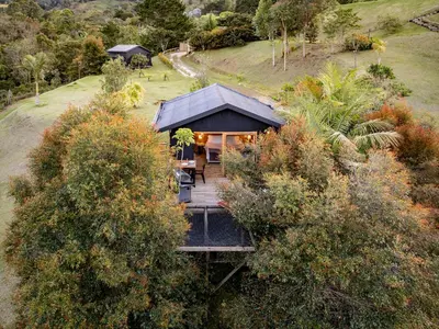 an overhead view of a house with a wooden deck at Retreat Villas Llanogrande By CHX in Rionegro