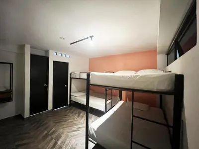a room with two bunk beds and a hallway at Hotel Natural Medellin in Medellín