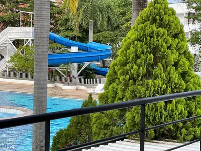a blue slide in a pool with a christmas tree at Hermoso Apartasol, cerca al Parque Principal, Piscinas, Aire acondicionado in Santa Fe de Antioquia