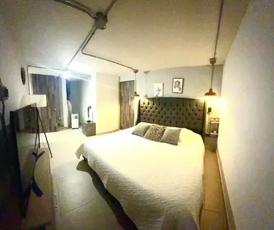 a bedroom with a large white bed in a room at Apartamento de lujo Poblado in Estación El Salto
