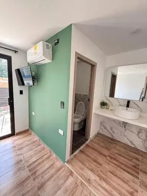 a bathroom with a sink and a toilet at View Theras Hotel in Doradal
