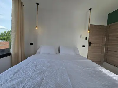 a bedroom with a large bed and a window at View Theras Hotel in Doradal