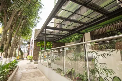 a building with a greenhouse with plants in it at Lleras Green Hotel in Medellín