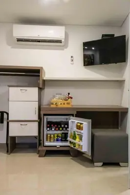 a kitchen with an open refrigerator in a room at Lleras Green Hotel in Medellín