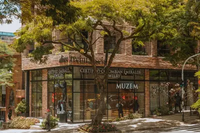 a store front of a brick building with a tree in front at 10-36 Dieztreintayseis Short & Long Term Living in Medellín