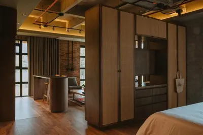 a bedroom with a bed and a desk and a kitchen at 10-36 Dieztreintayseis Short & Long Term Living in Medellín