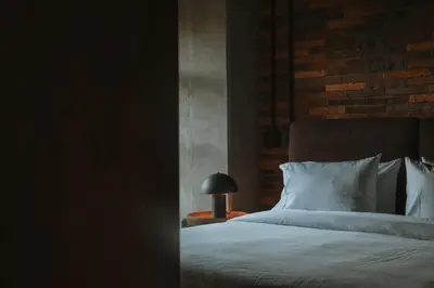 a bedroom with a bed and a lamp on a table at 10-36 Dieztreintayseis Short & Long Term Living in Medellín