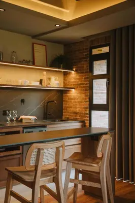 a kitchen with a table and two chairs and a sink at 10-36 Dieztreintayseis Short & Long Term Living in Medellín