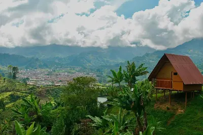 a small house on top of a hill with a valley at Hotel Cabañas Villa Loe Jardín in Jardin