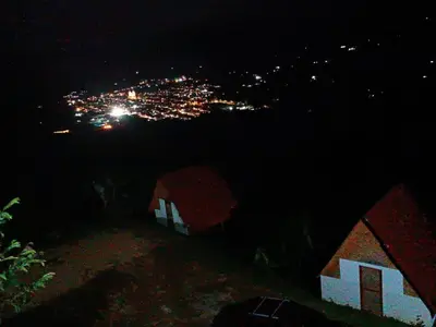 a view of a city at night with tents at Hotel Cabañas Villa Loe Jardín in Jardin