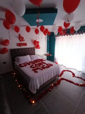 a bedroom with a bed with red and white balloons at finca hotel ganbaru