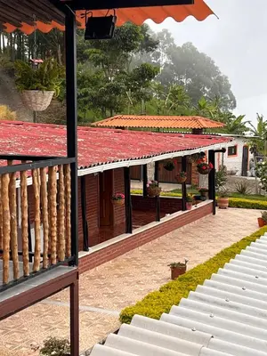 a house with a red roof and a patio at finca hotel ganbaru