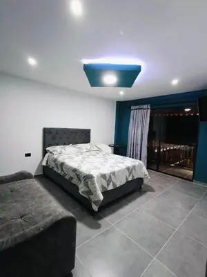 a bedroom with a bed and a blue light at finca hotel ganbaru