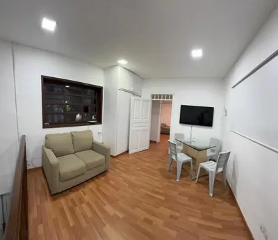 a living room with a couch and a table and a television at Apartamento Rosa colonial in Medellín
