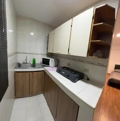 a small kitchen with a sink and a microwave at Apartamento Rosa colonial in Medellín