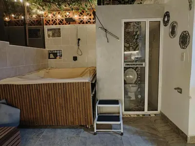 a bathroom with a tub and a chair in it at Apartamento con jacuzzi in Santa Fe de Antioquia