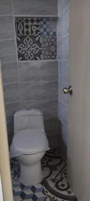 a bathroom with a white toilet in a room at Apartamento con jacuzzi in Santa Fe de Antioquia