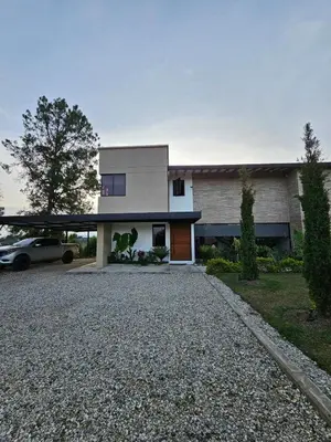 a house with a car parked in front of it at Finca de Lujo en Rionegro -30 min Airport -1 hr Guatapé in Rionegro