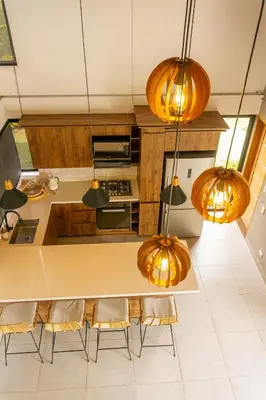 a kitchen with a table and chairs and lights at Finca de Lujo en Rionegro -30 min Airport -1 hr Guatapé in Rionegro