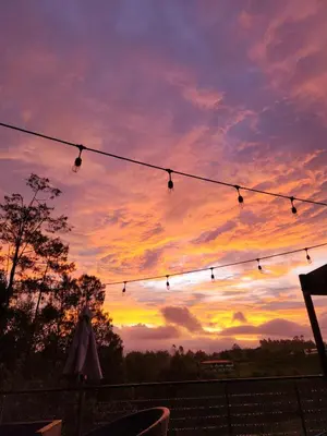 a string of lights with a sunset in the background at Finca de Lujo en Rionegro -30 min Airport -1 hr Guatapé in Rionegro