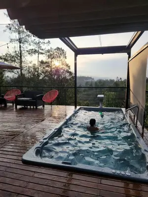 a man in a swimming pool on a deck at Finca de Lujo en Rionegro -30 min Airport -1 hr Guatapé in Rionegro