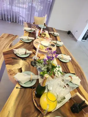 a long wooden table with plates of food on it at Finca de Lujo en Rionegro -30 min Airport -1 hr Guatapé in Rionegro