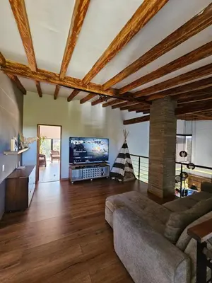 a living room with a couch and a tv at Finca de Lujo en Rionegro -30 min Airport -1 hr Guatapé in Rionegro