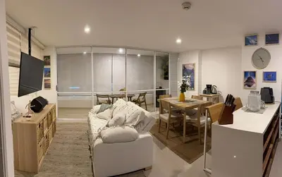 a living room with a couch and a dining room at Apartamento loft en Santa Fe de Antioquia in Santa Fe de Antioquia