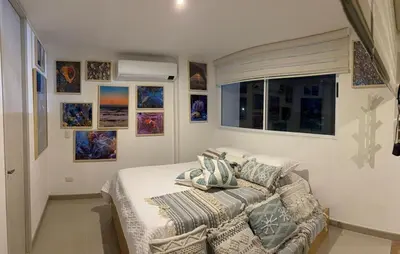 a bedroom with a bed with pillows and a window at Apartamento loft en Santa Fe de Antioquia in Santa Fe de Antioquia
