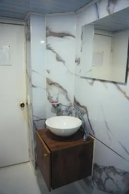 a bathroom with a sink and a mirror at Hotel Santorini la 70 in Medellín