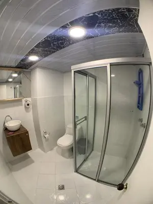 a bathroom with a glass shower and a toilet at Hotel Santorini la 70 in Medellín