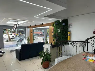 a living room with a couch in a building at Hotel Santorini la 70 in Medellín