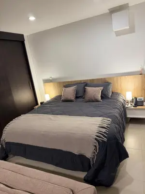 a bedroom with a large bed with two pillows at Hotel rioverde aparta suite cerca de aeropuerto JMC in José María Córdova International