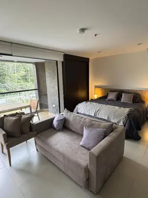 a bedroom with a bed and a couch and a bed at Hotel rioverde aparta suite cerca de aeropuerto JMC in José María Córdova International