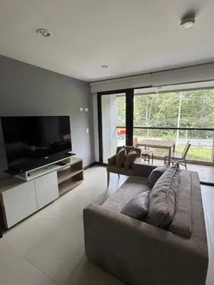 a living room with a couch and a flat screen tv at Hotel rioverde aparta suite cerca de aeropuerto JMC in José María Córdova International