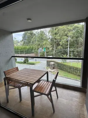 a table and a chair in front of a large window at Hotel rioverde aparta suite cerca de aeropuerto JMC in José María Córdova International