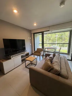 a living room with a couch and a flat screen tv at Hotel rioverde aparta suite cerca de aeropuerto JMC in José María Córdova International