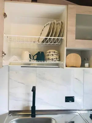 a kitchen with a sink and a shelf with dishes at Apartamento en Rionegro in Rionegro