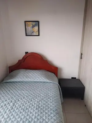 a bedroom with a bed and a picture on the wall at Apartamento en Rionegro in Rionegro