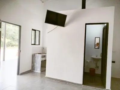 a bathroom with a mirror and a sink at JyM apartaestudios in Doradal