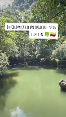 a sign over a body of water with a river at JyM apartaestudios in Doradal
