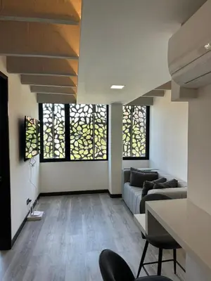a living room with a couch and some windows at Huge Apartment for families at Poblado in Medellín